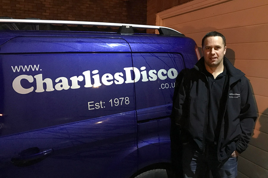 DJ Barry standing next to Charlie's Disco van